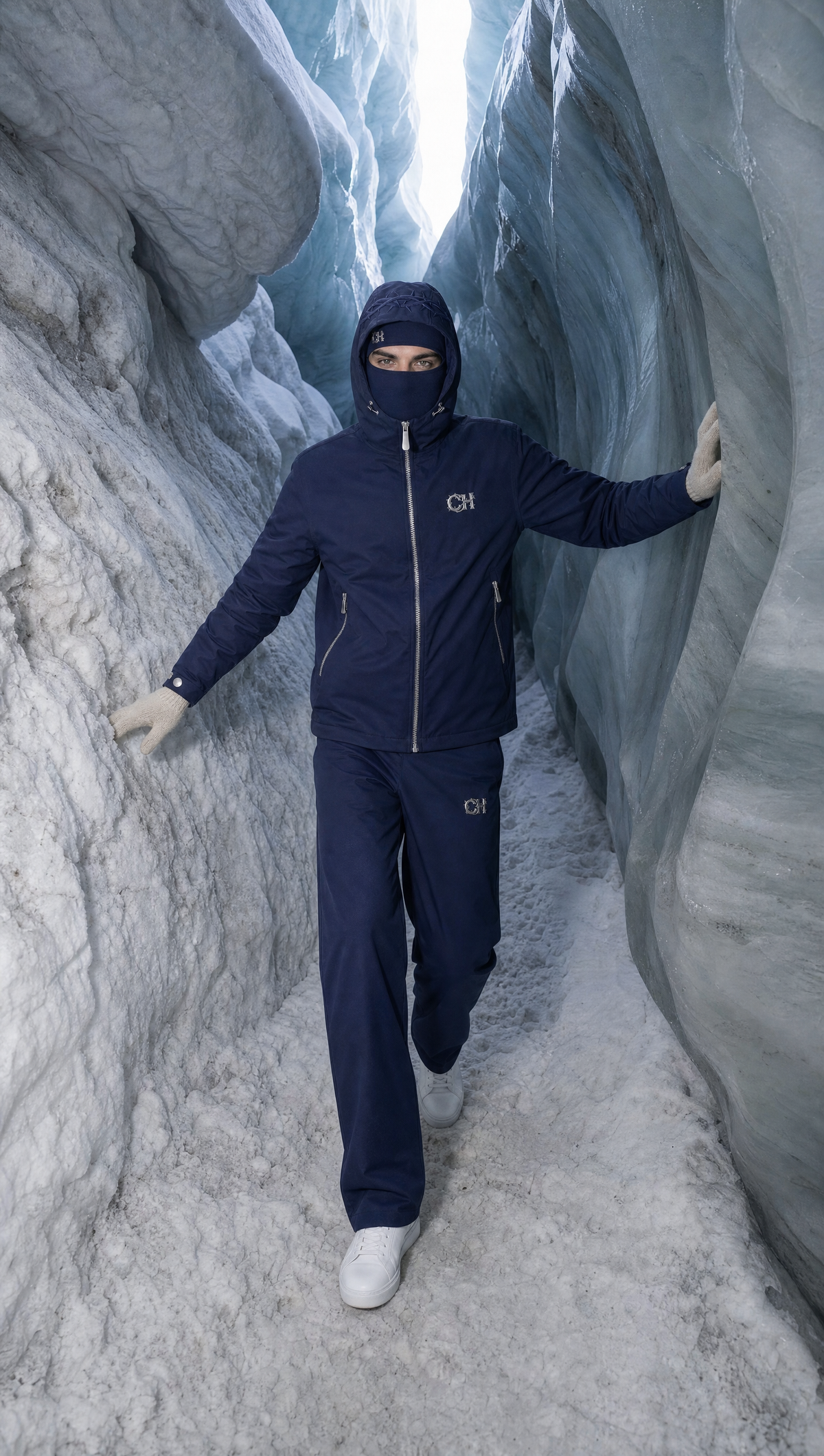 The navy EXODUS Rain Shell inside a glacier crevasse.